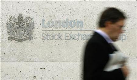 A man walks past the London Stock Exchange in the City of London A man walks past the London Stock Exchange in the City of London