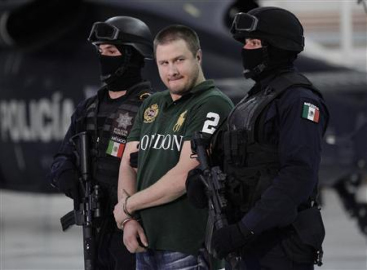 Major drug trafficker Edgar &quot;La Barbie&quot; Valdez is escorted by Mexican federal police during a news conference at the federal police center in Mexico City