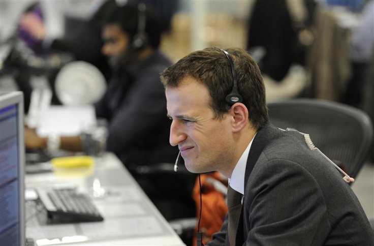 A trader on the IG Group dealing floor looks at his screens in the City of London