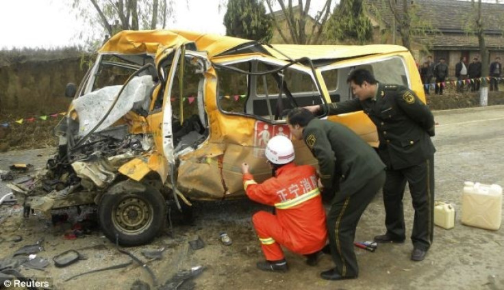 Rescuers inspect a school bus after it collided with a truck killing 18 children