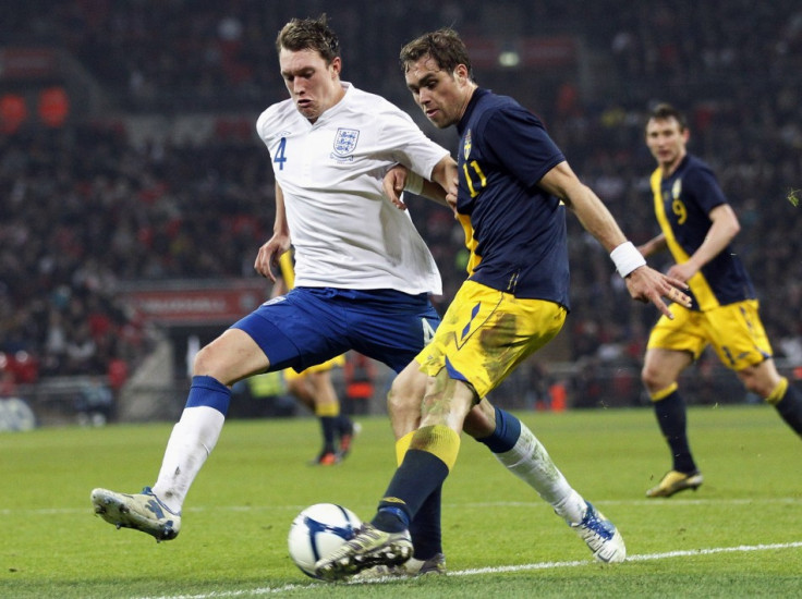 England's Phil Jones challenges Sweden's Johan Elmander during their international friendly soccer match in London
