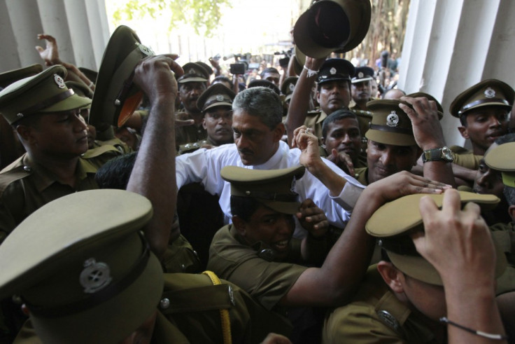 Jailed former army Chief Sarath Fonseka arrives with prison officers at the high court in Colombo