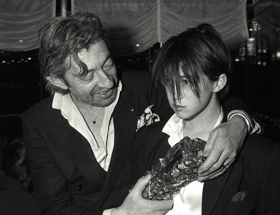 Serge Gainsbourg and his daughter Charlotte pose with Cesar award after the ceremonies in Paris February 23, 1986.
