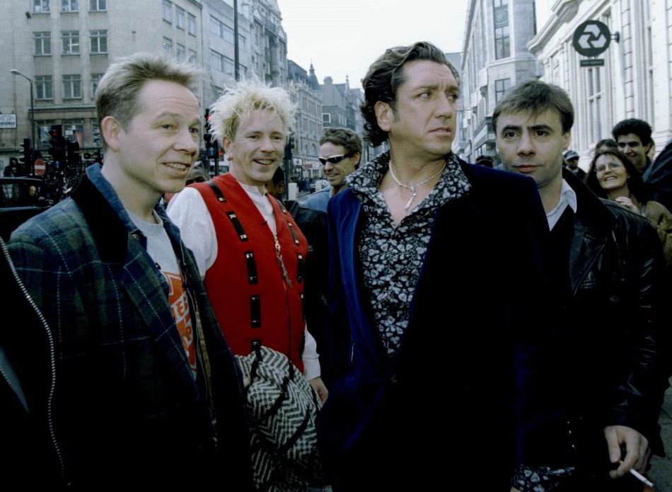 The four original members of the Sex pistols L-R Paul Cook, Johnny Rotten, Steve Jones, and Glen Matlock arrive at a press conference at the 100 Club in central London, March 18