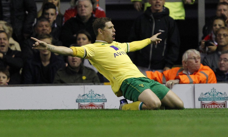 Norwich City&#039;s Holt celebrates after scoring during their English Premier League soccer match against Liverpool at Anfield in Liverpool