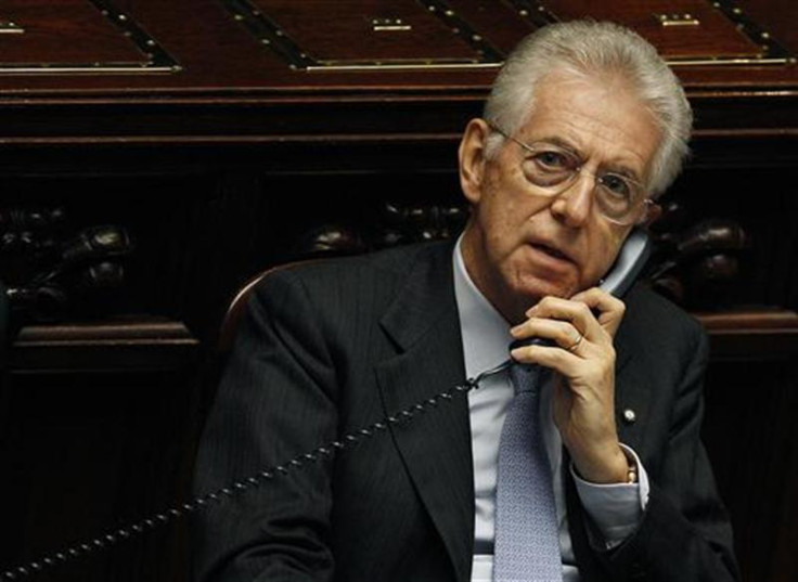 Italy's Prime Minister Mario Monti talks on the phone during a vote of confidence at the Lower House of Parliament in Rome