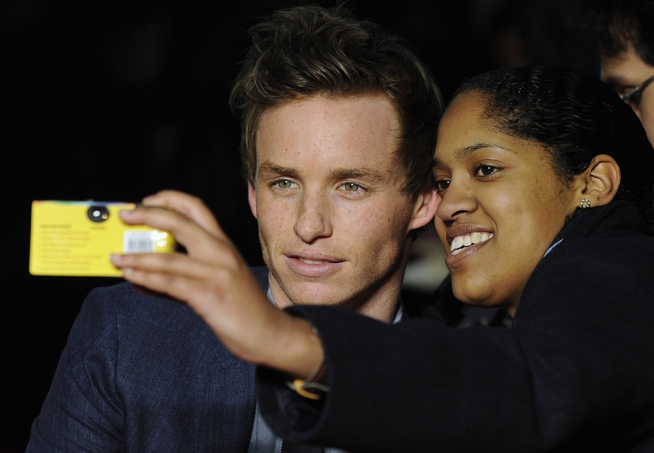Cast member Redmayne poses for a picture with a fan at the European premiere of quotMy Week With Marilynquot in London