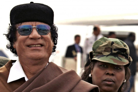 Libyan President Gaddafi is followed by his female bodyguard in Algiers.