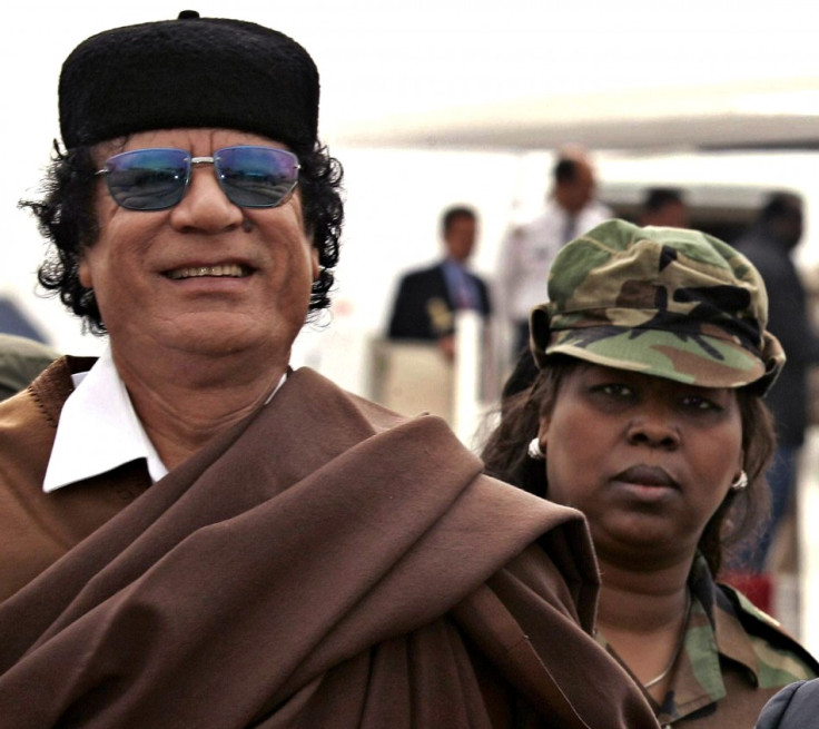 Libyan President Gaddafi is followed by his female bodyguard in Algiers.