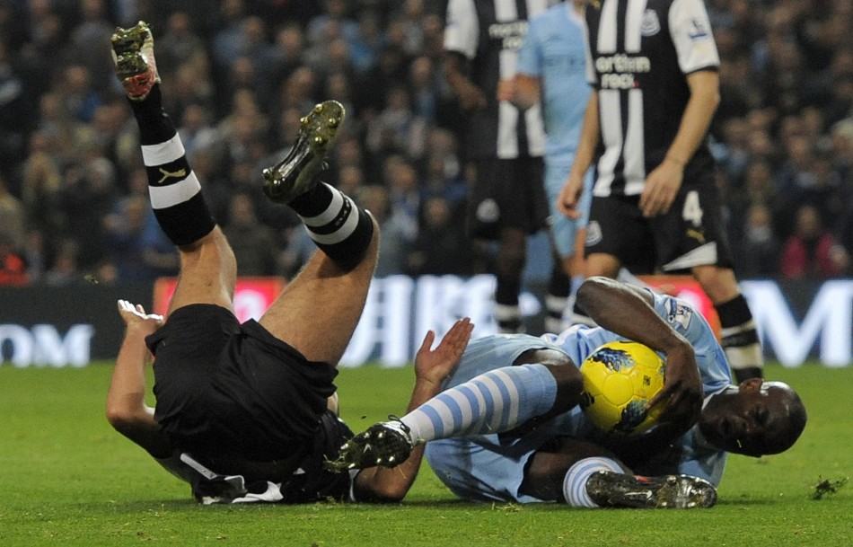 Newcastle Uniteds Arfa challenges Manchester Citys Richards to concede a penalty during their English Premier League soccer match in Manchester