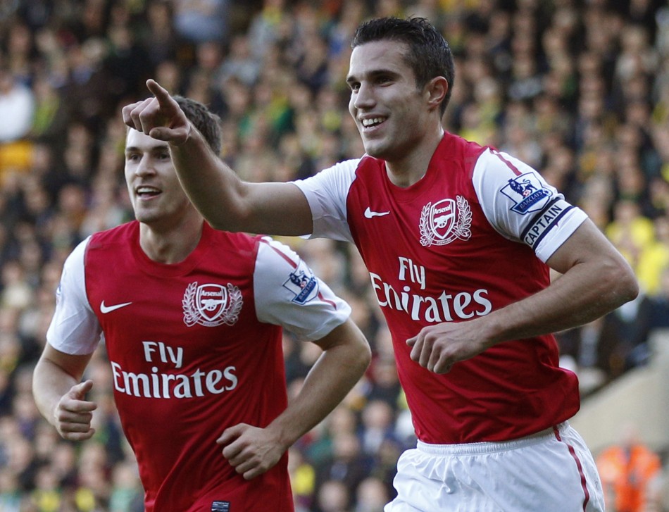Arsenals Robin Van Persie R celebrates his first goal against Norwich City