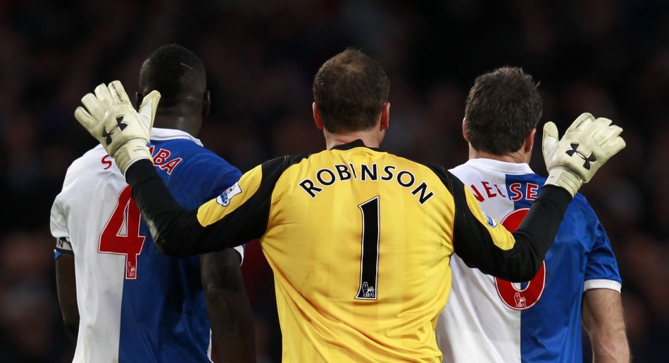 Blackburn Rovers goalkeeper Paul Robinson congratulates his defenders Christopher Samba and Ryan Nelsen after their English Premier League soccer match against Arsenal in London