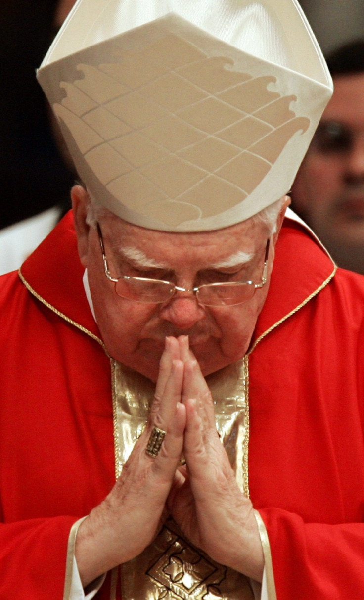 U.S. Cardinal Bernard Law prays during a mass in the Vatican's St. Peter's Basilica April 11, 2005. U.S. victims of child abuse by priests said on Monday the Catholic Church was "rubbing salt in an open wound" by allowing the cardinal