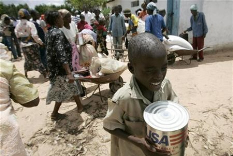 A boy carries a tin of cooking oil from a food aid distribution centre in Chirumanzi