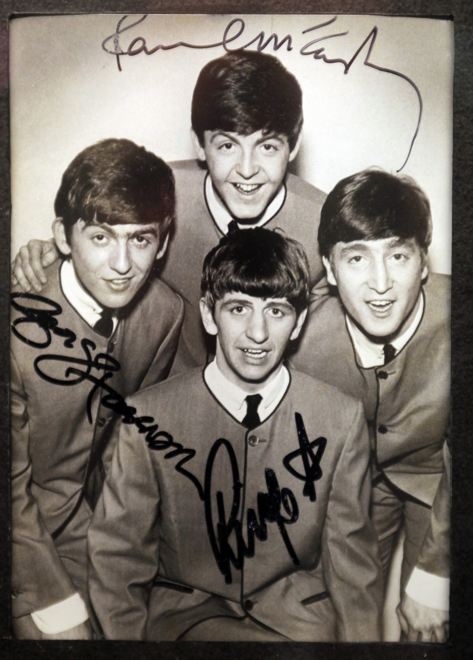 An autographed photo of The Beatles is displayed at an exhibition in Buenos Aires October 4, 2010.