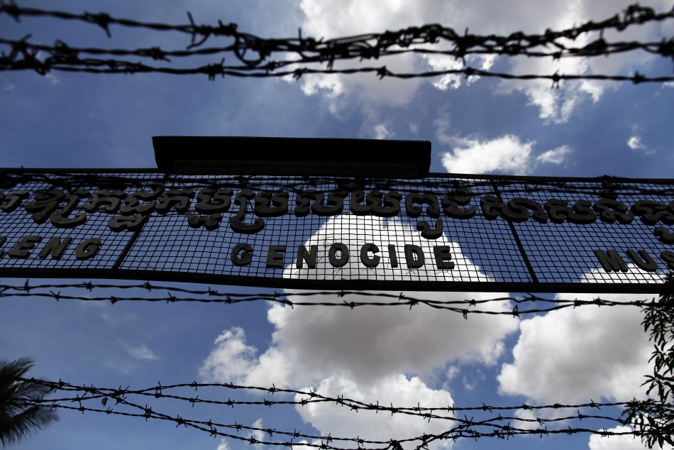 The sign above the entrance of Tuol Sleng Genocide Museum is seen through razor wire in Phnom Penh
