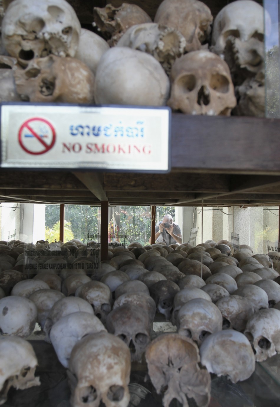 A tourist takes a photograph of skulls at a memorial stupa at Choeung Ek, a quotKilling Fieldsquot site located on the outskirts of Phnom Penh
