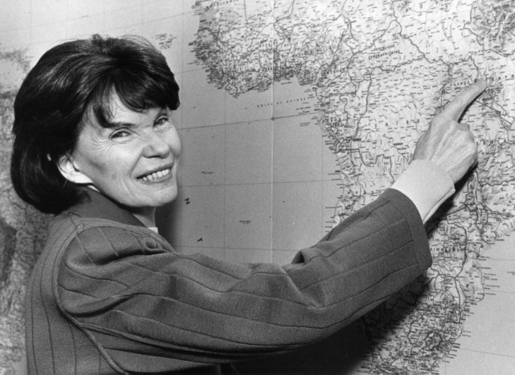 Danielle Mitterrand, the widow of former French President Mitterrand, points to a point in Kenya on a map of the world in her Paris office