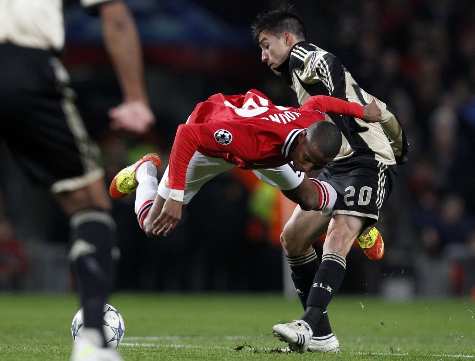 Benficas Gaitan challenges Manchester Uniteds Young during their Champions League Group C soccer match in Manchester