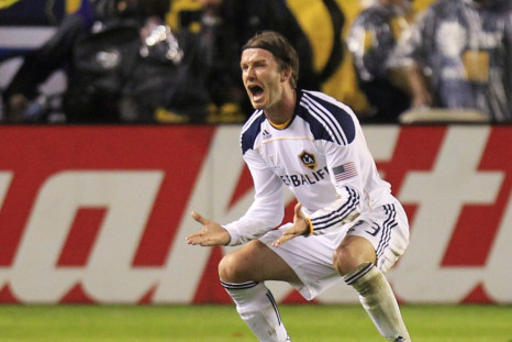 Los Angeles Galaxy's David Beckham reacts after teammate Landon Donovan scored against the Houston Dynamo during the MLS Cup final