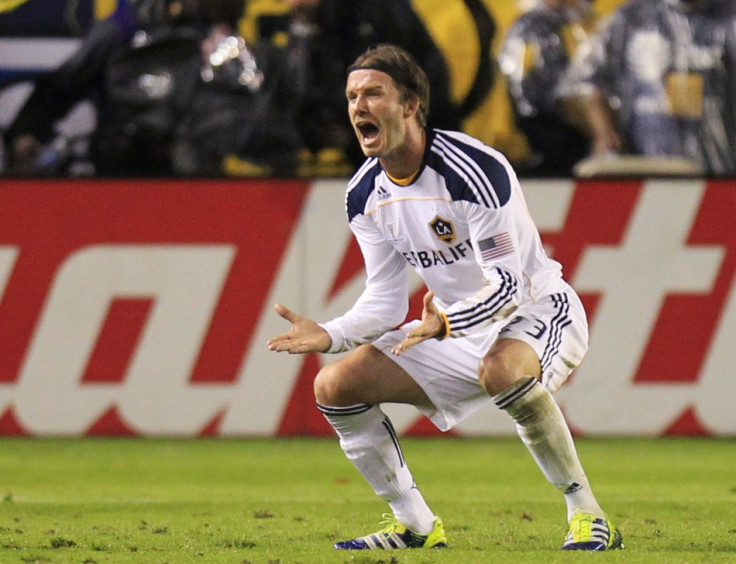Los Angeles Galaxy's David Beckham reacts after teammate Landon Donovan scored against the Houston Dynamo during the MLS Cup final