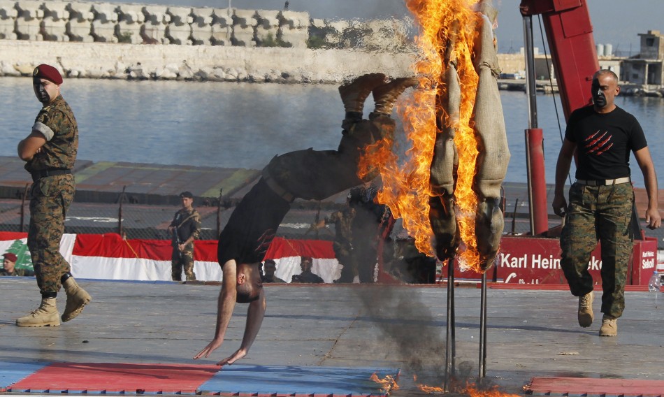 A commando jumps through a flaming hoop during a military parade to celebrate the 68th anniversary of Lebanons independence day in Beirut