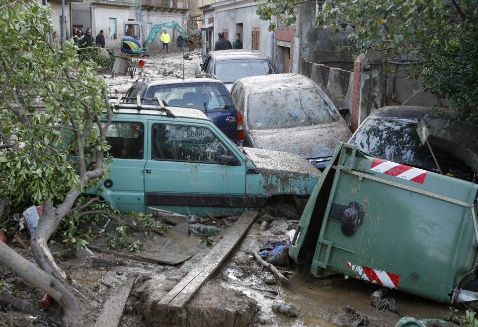 Cars are seen stranded in mud following a landslide at Scarcelli, a district of Saponara, in the province of Messina, in Sicily November 23, 2011