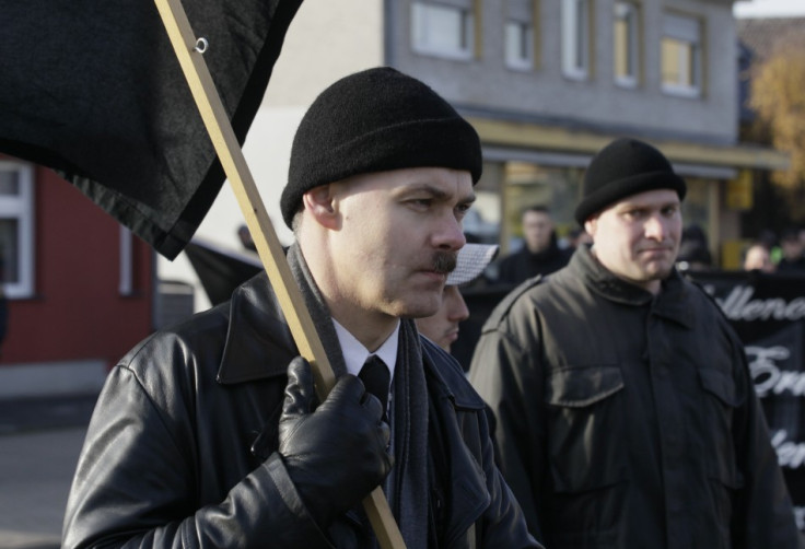 A neo-Nazi carries a black flag during an ultra right-wing rally in Remagen