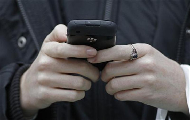 A woman uses her mobile telephone in central London