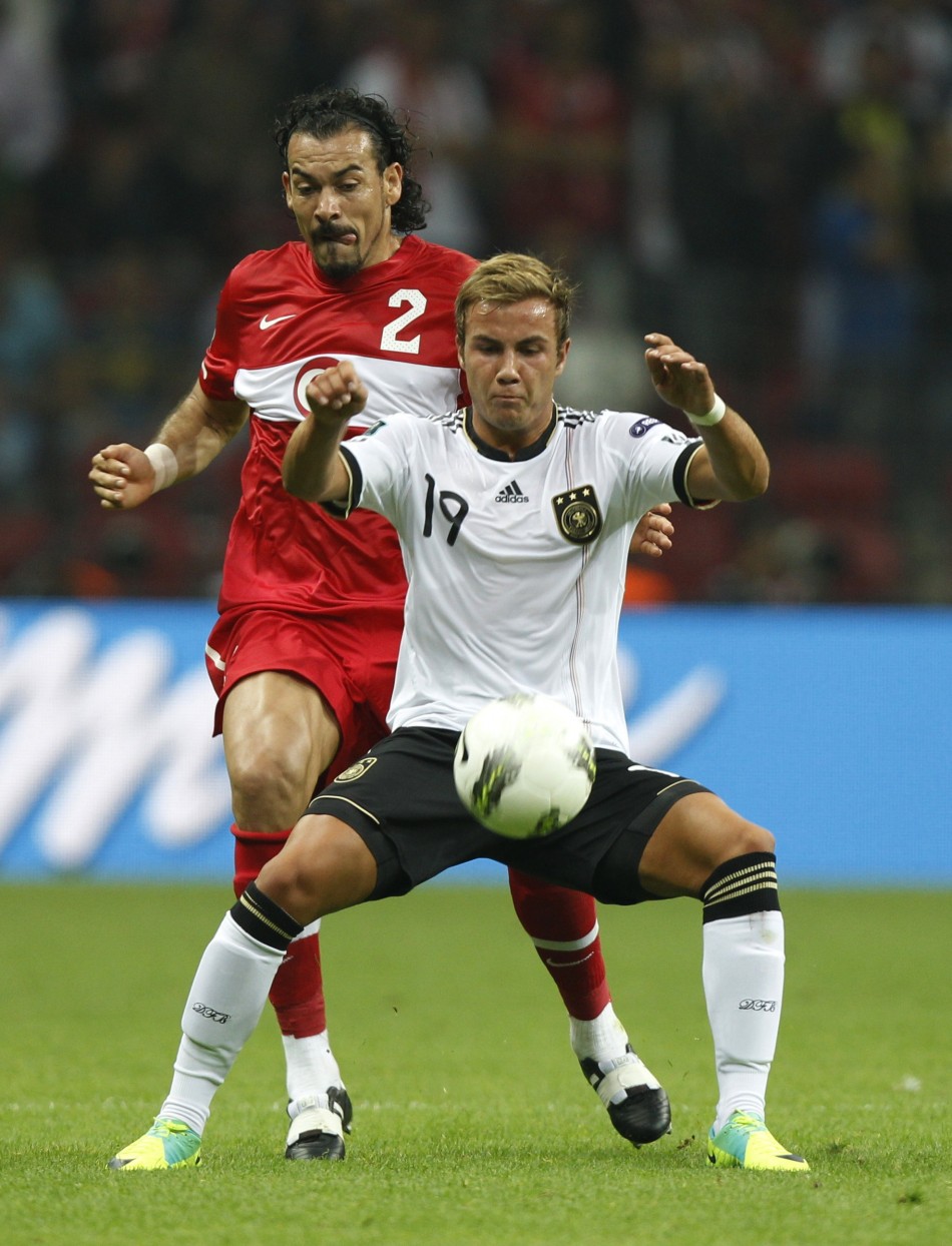 Germanys Gotze challenges Turkeys Cetin during their Euro 2012 qualifying Group A soccer match at Turk Telekom Arena in Istanbul