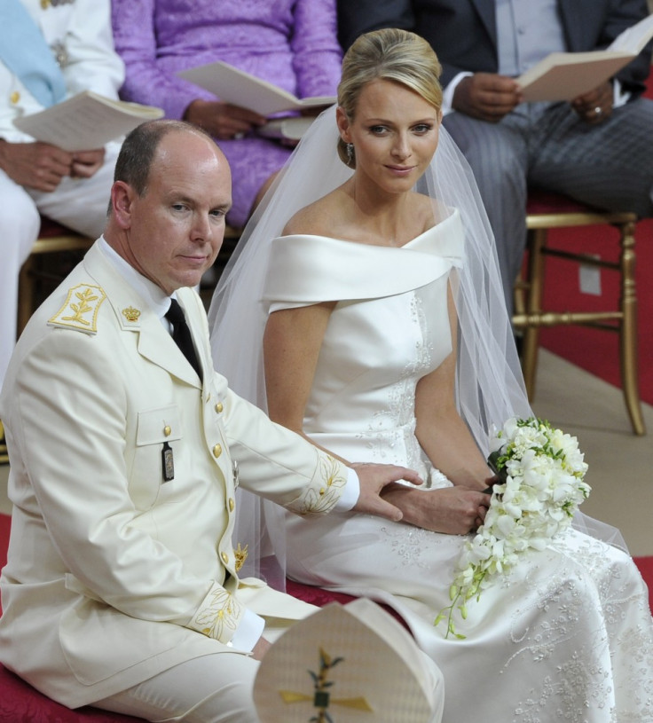 Prince Albert II of Monaco (L) reaches out for Princess Charlene's hand during their religious wedding ceremony at the Palace in Monaco July 2, 2011. REUTERS/Bruno Bebert/Pool