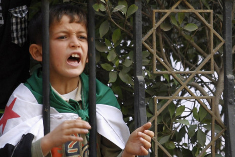 A Syrian boy shout slogans against Syrian President Assad during a protest