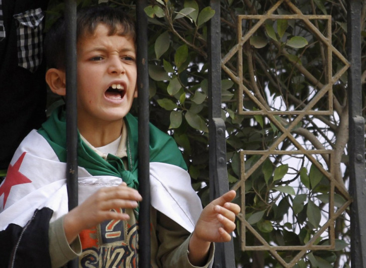 A Syrian boy shout slogans against Syrian President Assad during a protest
