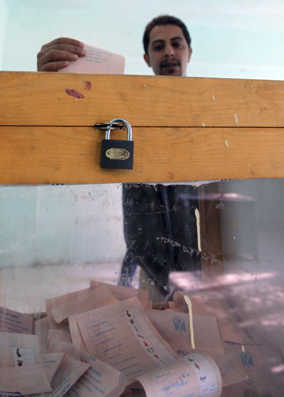 A man casts his vote at a polling station during parliamentary elections in Cairo