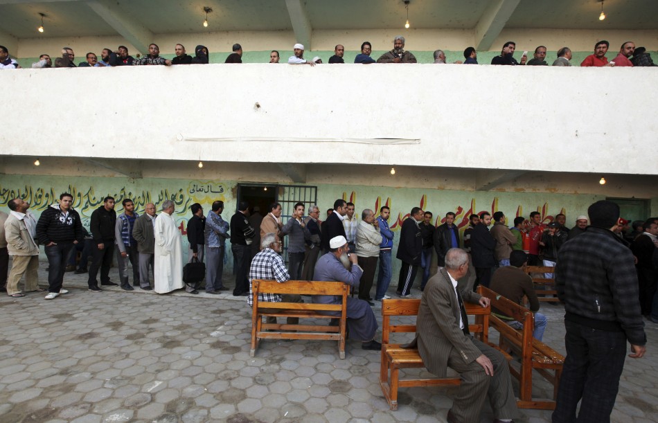 People queue at a polling station as they wait to cast their votes during parliamentary elections in Cairo