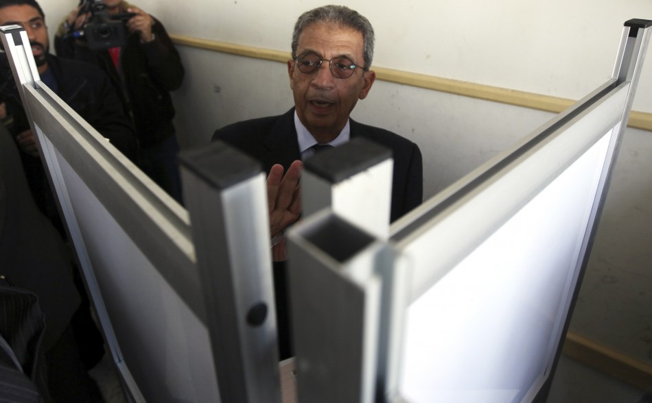 Presidential candidate Amr Moussa arrives to cast his vote at a polling station during a parliamentary election in Cairo