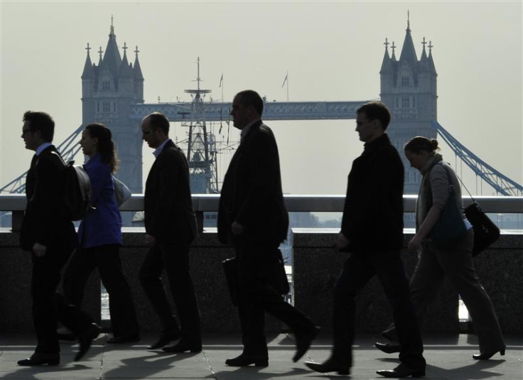 City workers cross London Bridge during the morning rush hour in London