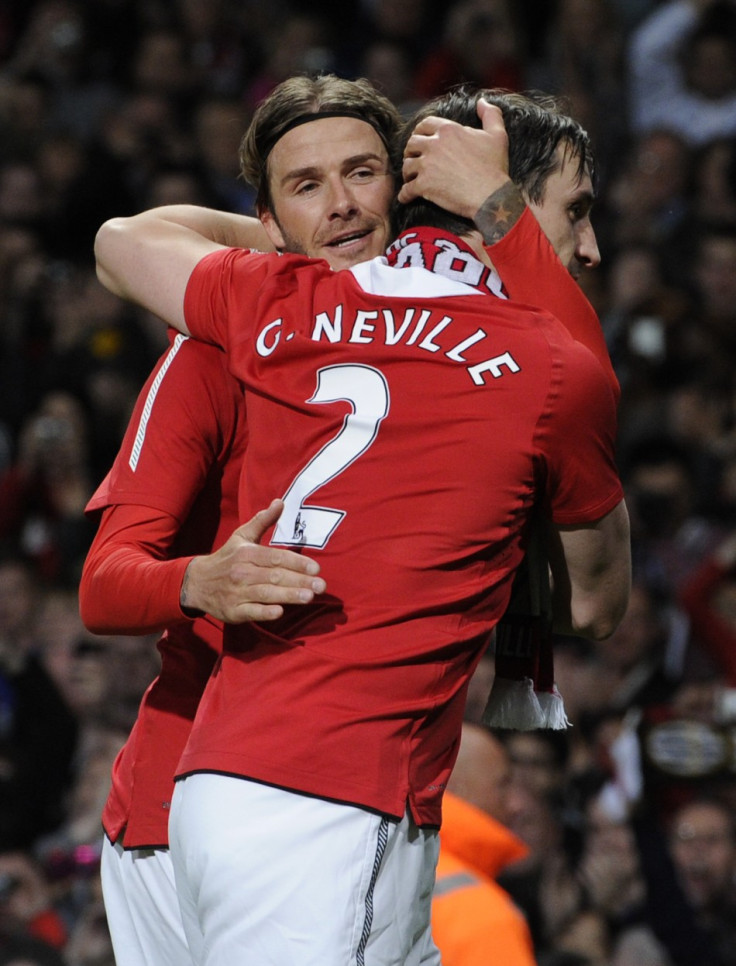 Manchester United&#039;s former player Beckham hugs Neville during Neville&#039;s testimonial soccer match against Juventus in Manchester