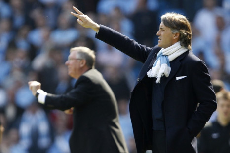 Manchester City&#039;s manager Mancini and his Manchester United counterpart Ferguson gesture during their English Premier League soccer match in Manchester