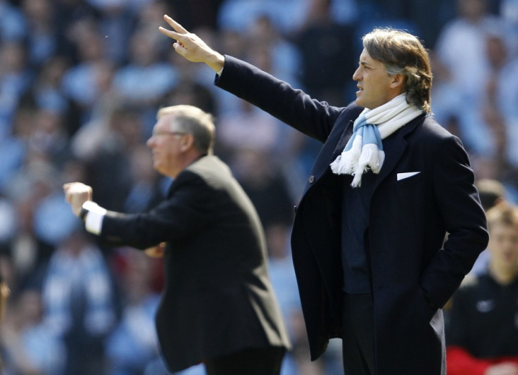 Manchester City&#039;s manager Mancini and his Manchester United counterpart Ferguson gesture during their English Premier League soccer match in Manchester