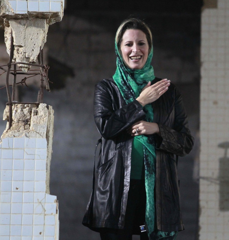 Aisha Gaddafi, daughter of Libya&#039;s leader Muammar Gaddafi, gestures during a pro-government rally at the heavily fortified Bab al-Aziziya compound in Tripoli