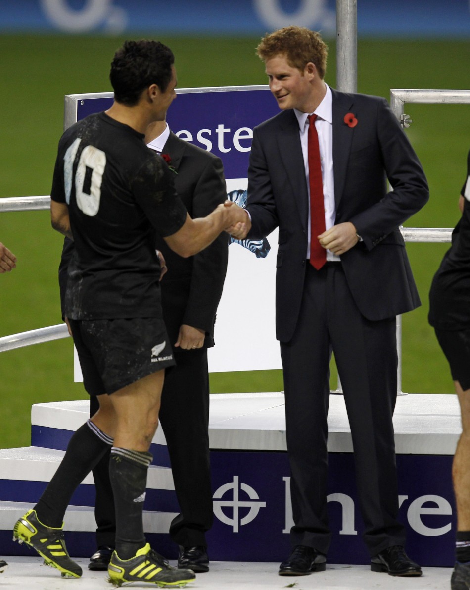 Britains Prince Harry R shakes hands with New Zealands Dan Carter after they won their friendly international rugby match match against England at Twickenham in London November 6, 2010
