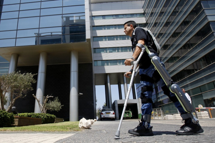 Radi Kaiof walks using an electronic exoskeleton at a development center in the northern city of Haifa