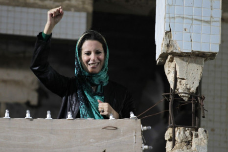 Aisha Gaddafi, daughter of Libya&#039;s leader Muammar Gaddafi,greets her father&#039;s supporters