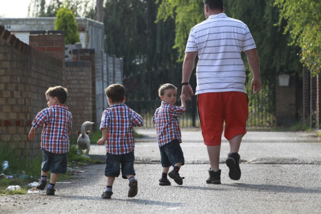 A man walks with his three children