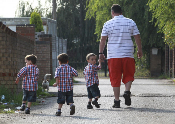 A man walks with his three children