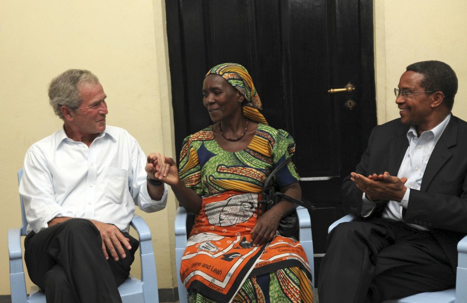 Former U.S. President George Bush and Tanzanian President Jakaya Kikwete congratulate cancer survivor Theresia Cosmas Chibongo as they visit Ocean Road Cancer Institute in Dar es Salaam