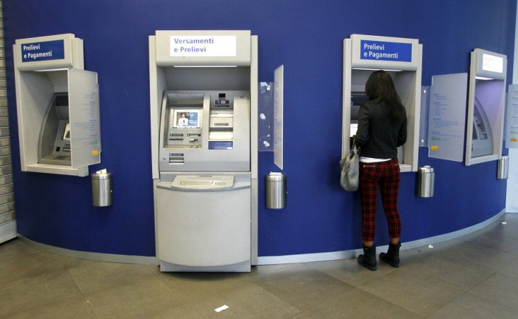 A woman using a ATM machine