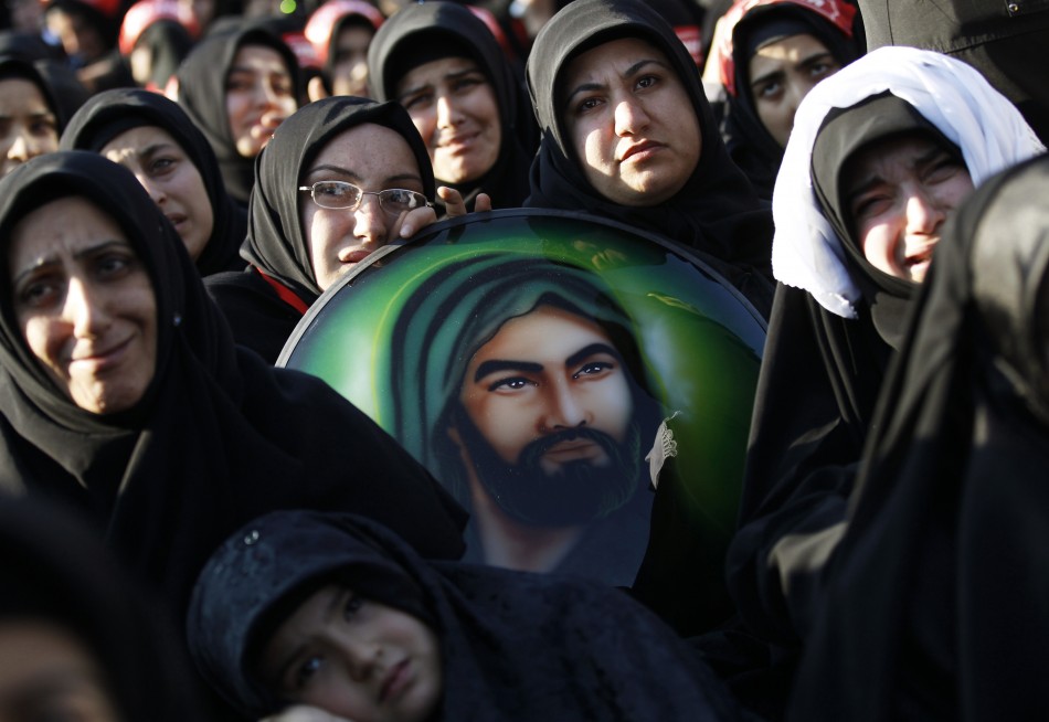 Shiite women holding a portrait of Hazrat Ali, son-in-law of Prophet Mohammad, mourn during an Ashura procession in Istanbul