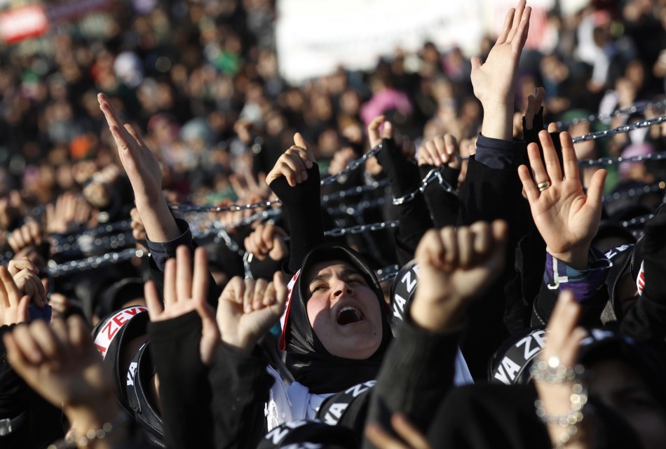 Shiite women shout Islamic slogans as they mourn during an Ashura procession in Istanbul